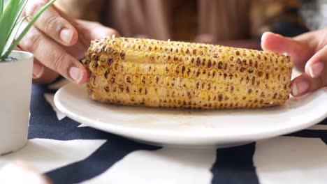 Women-holding-a-corn-cob-,