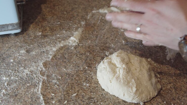 Tossing flour over pizza dough