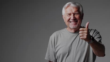 smiling senior man giving a thumbs up