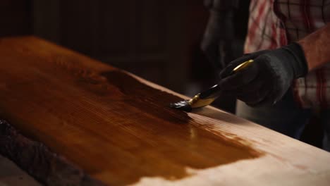 applying wood stain to a slab table