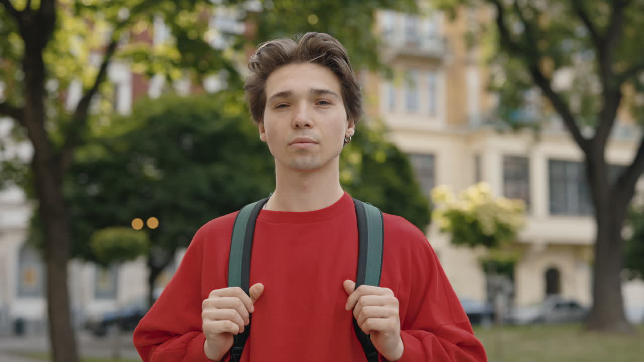 Portrait of a man with a backpack outdoors