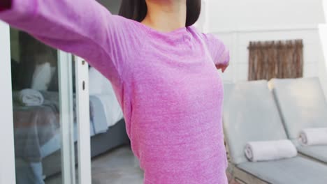 biracial woman practicing yoga and stretching in garden