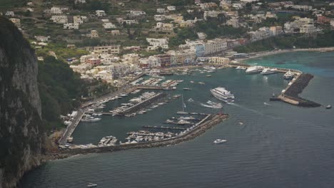 aerial view of a ferry and other boats arriving in marina grande port, in capri