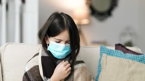 close-up portrait of sick girl sitting at home, sneezing and coughing