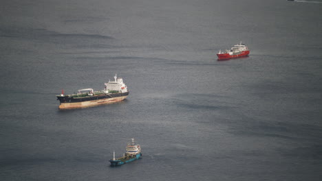 cargo vessels moored and waiting for line to enter port