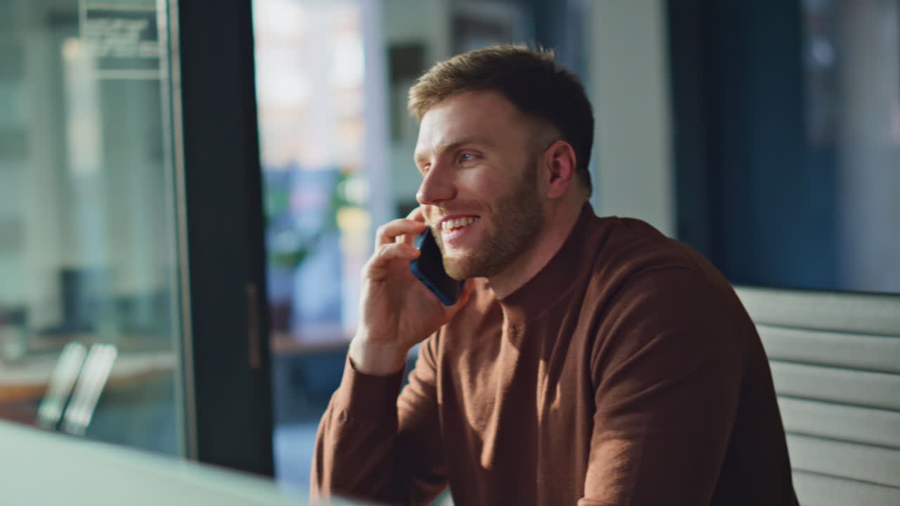 Positive consultant talking mobile phone in office closeup. Professional manager