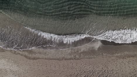 top down view of waves on the beach