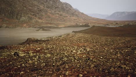 Atmospheric-landscape-with-mountain-lake-among-moraines-in-rainy-weather