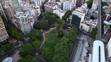 Orbital-of-Barrancas-de-Belgrano-park-near-train-station-surrounded-by-buildings-in-busy-Buenos-Aires-city,-Argentina