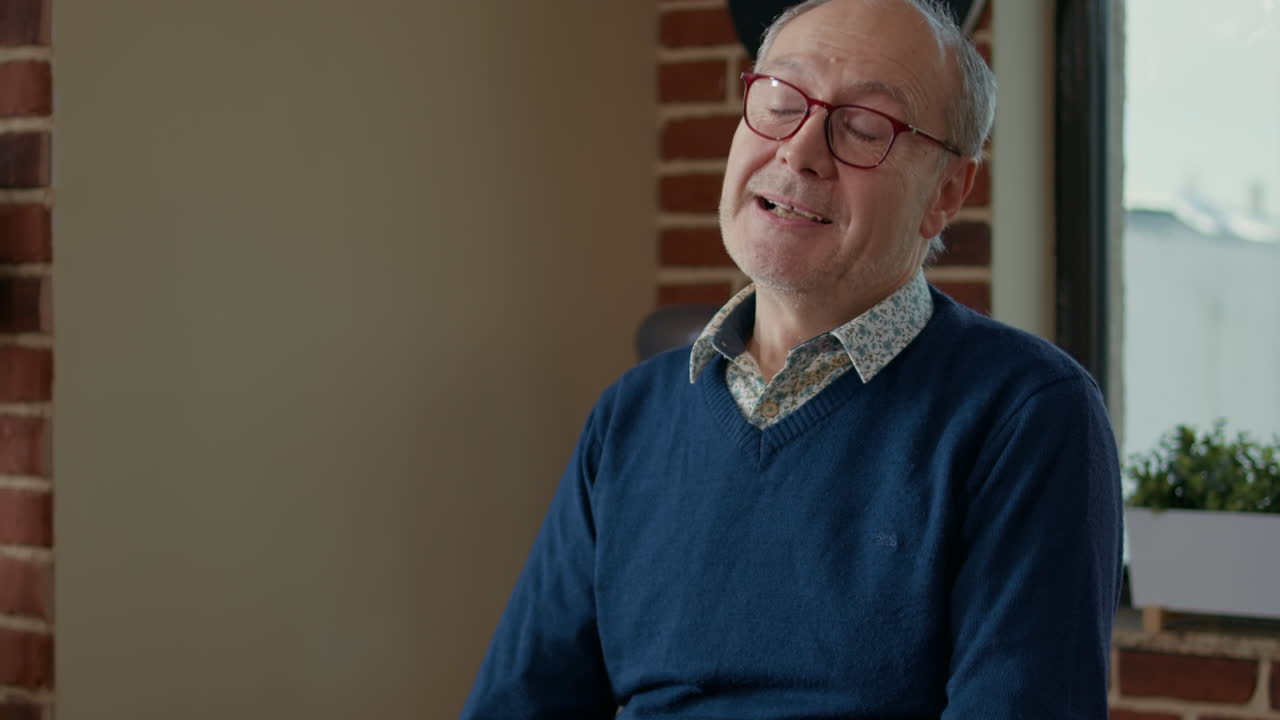 Elder artist teaching people at art class to draw masterpiece on canvas