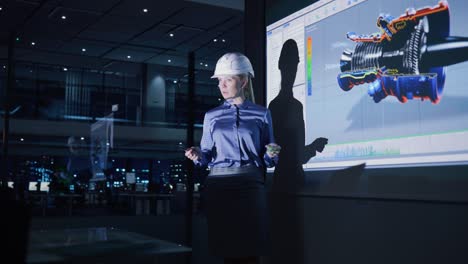 presentación de la conferencia de tecnología de energía verde: ingeniera automotriz femenina jefe diseño de motor ambiental sostenible para inversores y empresarios. la pantalla muestra un modelo 3d de la turbina de electricidad