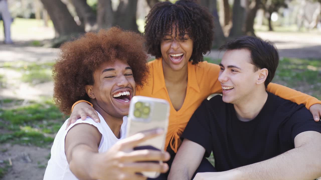 Cheerful diverse friends taking selfie