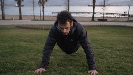 young man sit-up in park