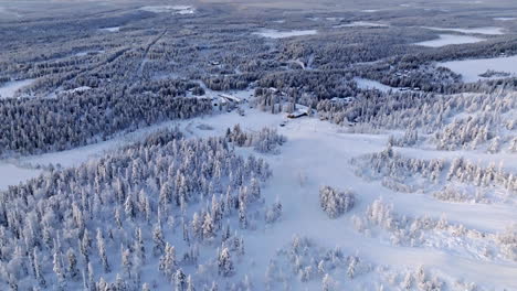 drone overlooking frozen nature and the slopes of salla, winter day in finland