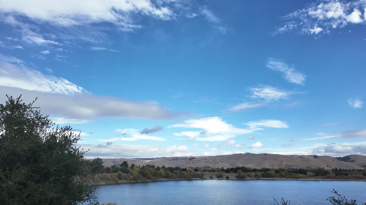 A top-down motion captures shifting light over Fremont’s Quarry Lakes area, highlighting trails, trees, and the reflective water as dusk settles across the natural space in a smooth time-lapse reveal