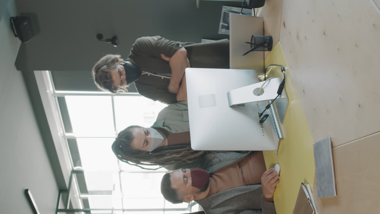 Vertical Shot of Team of Businesspeople in Face Masks Working