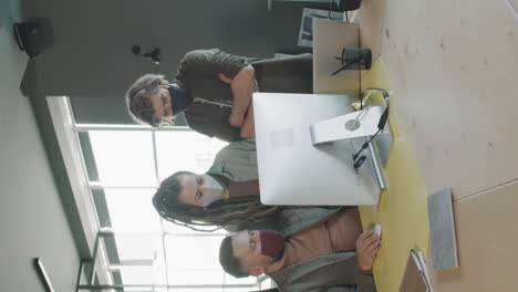 vertical shot of team of businesspeople in face masks working