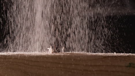 Slow-Motion-Of-Falling-Wood-Shavings-On-Wooden-Block