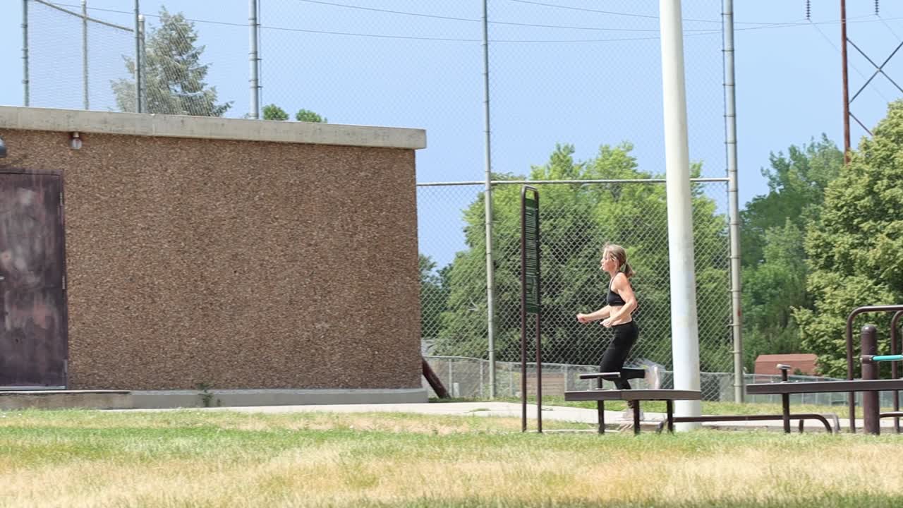 A woman gets her cardio by running through an urban park