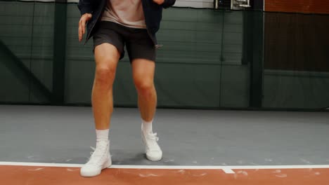 man jumping on a tennis court