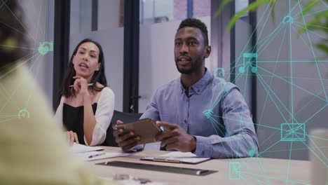 animation of network of connections with icons over diverse business people discussing work