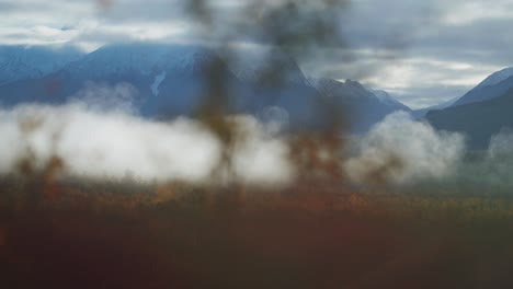 Fog-creeps-above-the-forest-covered-valley-in-the-autumn-tundra