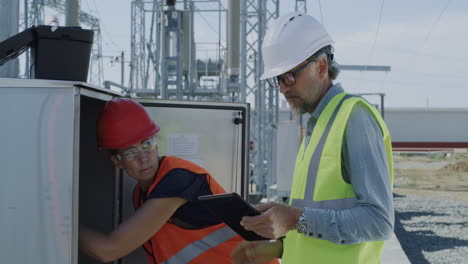 electrical engineers inspecting equipment at a power station