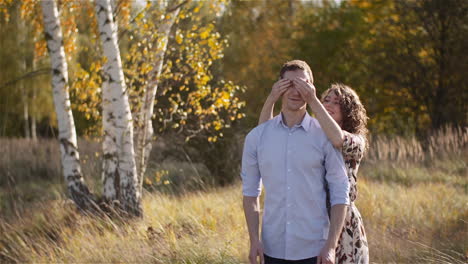 joyful couple hugging in sunny meadow