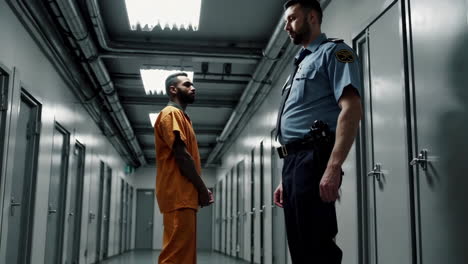 police officer and prisoner in jail hallway