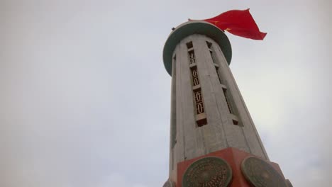 looking up to lũng cú flag tower with vietnamese flag fluttering in the wind