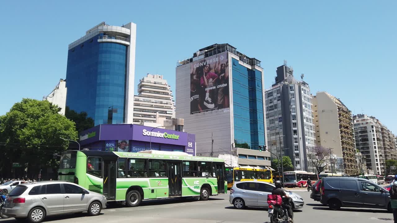 Panning shot at Juan b. Justo Avenue, landmark of Palermo neighborhood, skyscrapers and city traffic at daylight motion