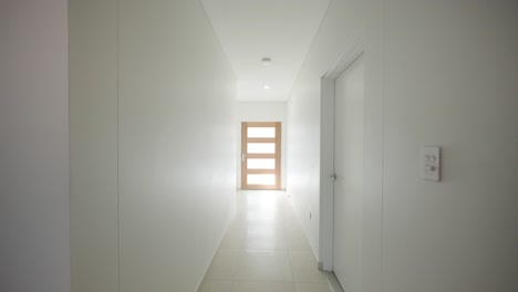 modern display home kitchen transitioning into the bedroom with open-plan design and sleek furnishings, real estate staging.