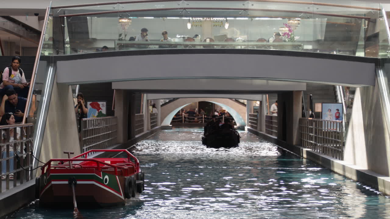 Tourists are enjoying SAMPAN Rides in Marina Bay Sands shopping center