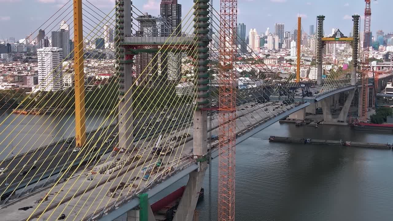 Construction of a bridge over a river in Bangkok during the day