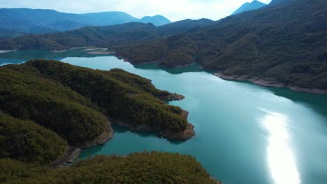 pristine waters of bovilla reservoir surrounded by mountain scenery, stunning tourist landscape in albania
