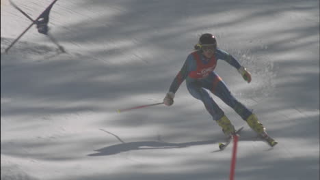 a skier skis downhill hitting two flags