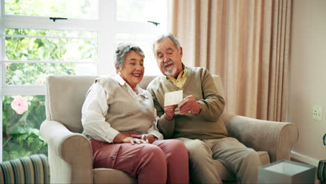 Elderly Couple Looking at Old Photo Together