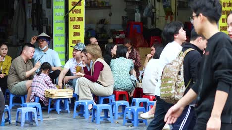 people sitting and socializing at a street cafe