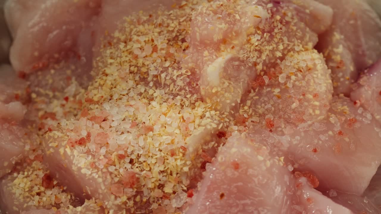 Man slicing raw turkey or chicken meat fillet on oak cutting board closeup, cooking with knife on restaurant kitchen. High quality 4k footage