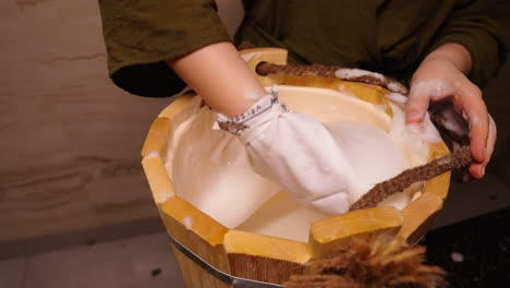 washing hands in a wooden bucket