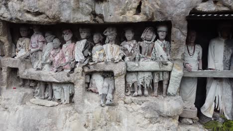 tau tau effigies in toraja burial cliff
