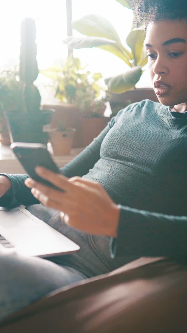 Young Woman Using Smartphone and Laptop at Home