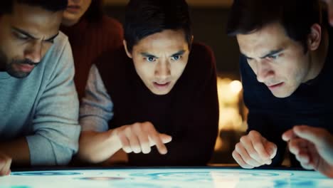 engaged focus: a group of friends analyzing an interactive display with intense concentration and curiosity, exploring technology together