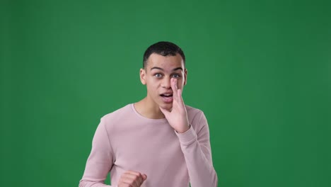 man sharing secrets over green background