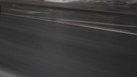 wet asphalt road with white markings in rainy weather in the city center