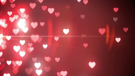 Animation-of-illuminated-heart-shapes-moving-against-red-background