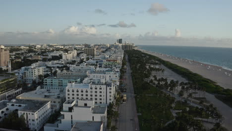 South-Beach-Miami,-Ocean-Drive-Aerial-perspective-with-shops-and-coastline-during-sunrise