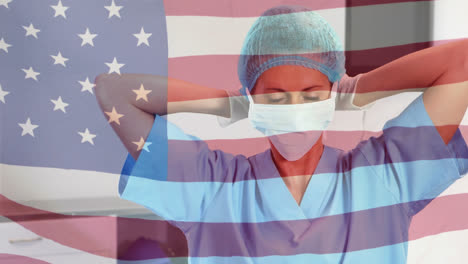 Animation-of-flag-of-usa-waving-over-female-surgeon-in-operating-theatre