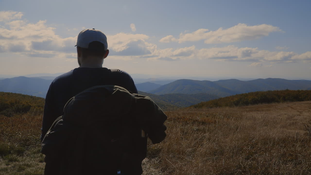Backpacker and his dog at the top of the hill