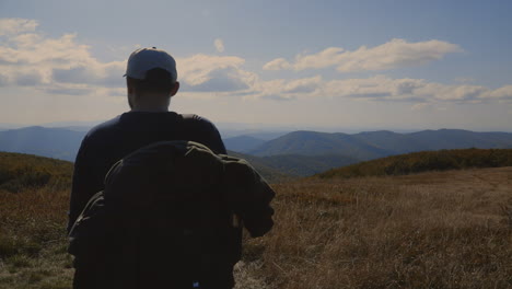 backpacker and his dog at the top of the hill